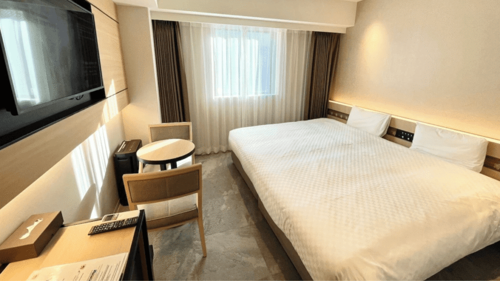 Clean and spacious wide bed with enough room for two adults and a child to sleep together.