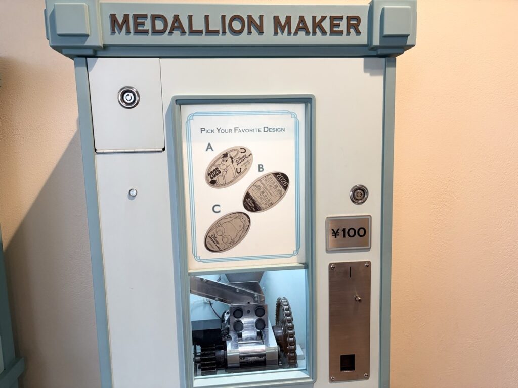 リゾートラインステーションのメダル発行機（100円・青いデザイン）