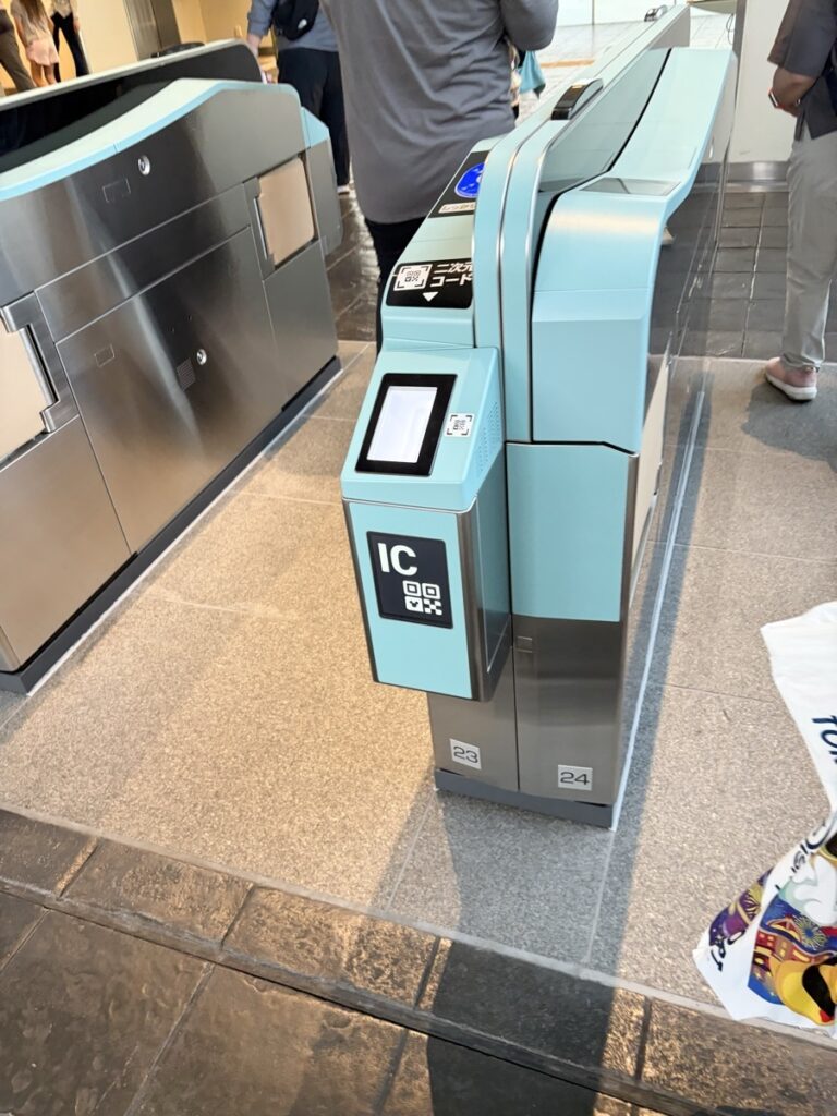 Disney Resort Line ticket gate — barcode scanner panel, not an insertion slot