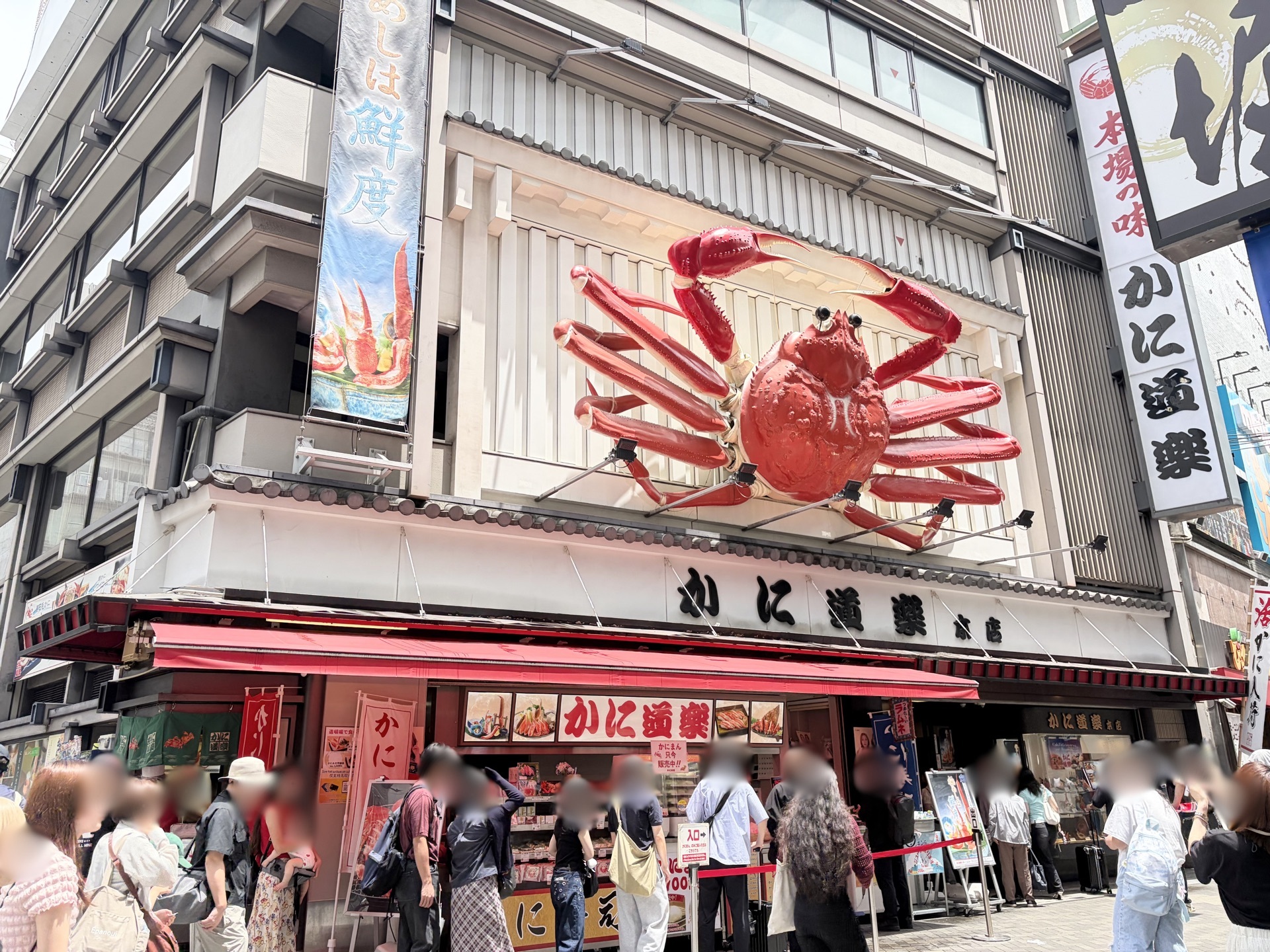 Kani Doraku giant crab sign, Dotonbori Osaka | Landmark pointing towards Glico Man sign