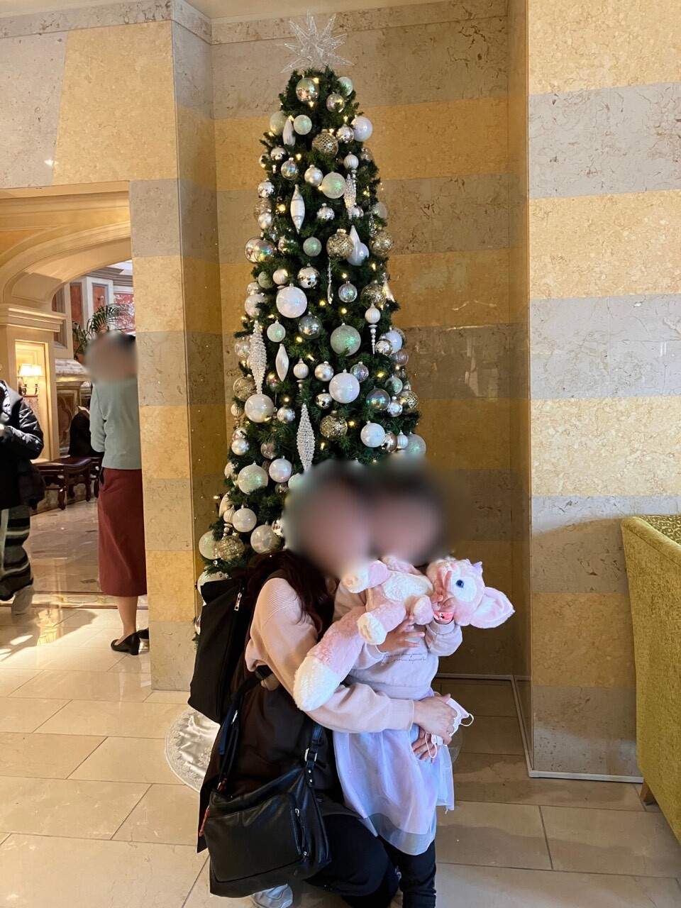White and silver Christmas tree in the marble lobby area of Tokyo DisneySea Hotel MiraCosta