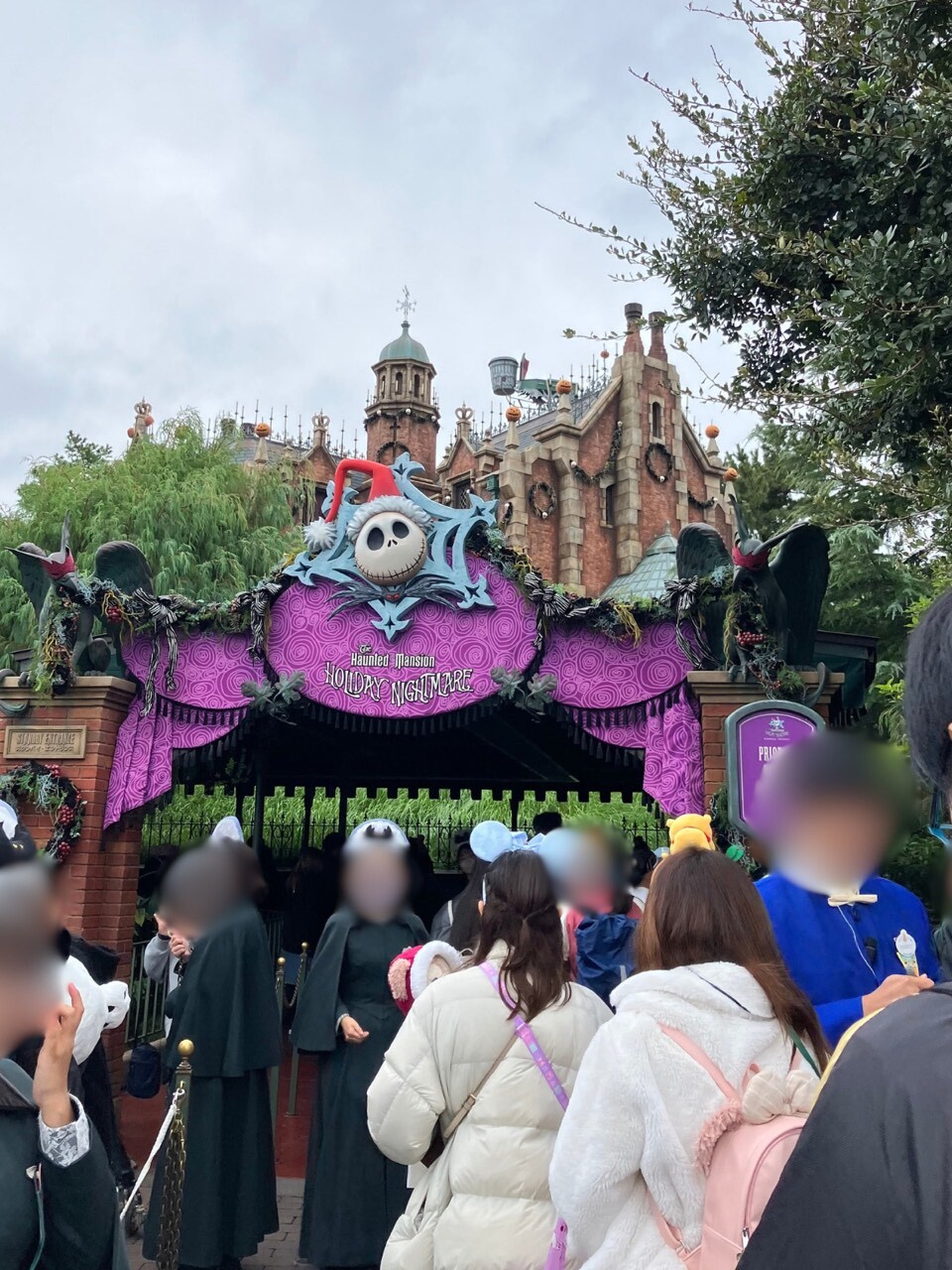 Haunted Mansion Holiday Nightmare entrance at Tokyo Disneyland with Jack Skellington sign and pumpkins on the roof